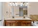 Bathroom with double sink vanity, a large mirror and a soaking tub at 1973 Cobblestone Cir, Brookhaven, GA 30319