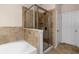 Beautiful bathroom with tub and step-in shower with tile walls and glass door at 1973 Cobblestone Cir, Brookhaven, GA 30319