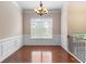 Bright dining room featuring hardwood floors, wainscoting and a chandelier at 1973 Cobblestone Cir, Brookhaven, GA 30319