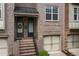Brick townhome with covered stairway entrance and attached garages at 1973 Cobblestone Cir, Brookhaven, GA 30319