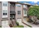 Brick townhomes with garages and stairway entrances, complemented by lush landscaping at 1973 Cobblestone Cir, Brookhaven, GA 30319