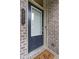 Modern front door with window panel set in brick facade at 1973 Cobblestone Cir, Brookhaven, GA 30319