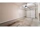 View of the empty garage with a concrete floor and a closed garage door at 1973 Cobblestone Cir, Brookhaven, GA 30319