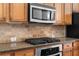 Close up on kitchen details including the stove, microwave, and granite countertops at 1973 Cobblestone Cir, Brookhaven, GA 30319