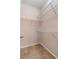 Walk-in closet with white wire shelving and tan carpet at 1973 Cobblestone Cir, Brookhaven, GA 30319