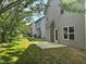 Green backyard with a concrete patio and view of adjacent homes at 678 Sweet Ashley Way, Loganville, GA 30052