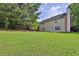 Expansive backyard with lush green lawn and mature trees, perfect for outdoor activities at 1280 Chandler Ridge Dr, Lawrenceville, GA 30045