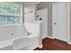 Bathroom featuring a tub, walk in shower, and wood-style floors at 1280 Chandler Ridge Dr, Lawrenceville, GA 30045