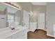 Bathroom featuring a double vanity, tub, and wood-style floors at 1280 Chandler Ridge Dr, Lawrenceville, GA 30045