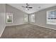 Spacious bedroom featuring neutral walls, plush carpeting, and a ceiling fan at 1280 Chandler Ridge Dr, Lawrenceville, GA 30045