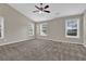 Spacious bedroom featuring neutral walls, plush carpeting, and a ceiling fan at 1280 Chandler Ridge Dr, Lawrenceville, GA 30045