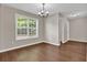 The dining room offers natural light from the large window and a stylish chandelier at 1280 Chandler Ridge Dr, Lawrenceville, GA 30045