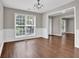 Bright dining room featuring wainscoting, a chandelier, and a large window at 1280 Chandler Ridge Dr, Lawrenceville, GA 30045