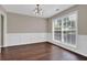 Bright dining room with decorative wainscoting, hardwood floors, and a large window at 1280 Chandler Ridge Dr, Lawrenceville, GA 30045