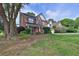 Charming two-story home featuring a brick facade, red shutters, and well-manicured landscaping at 1280 Chandler Ridge Dr, Lawrenceville, GA 30045