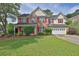 Charming two-story home with red shutters, brick accents, and a well-manicured lawn at 1280 Chandler Ridge Dr, Lawrenceville, GA 30045