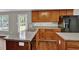 Well-equipped kitchen with stainless steel appliances, dark wood cabinets, and laminate countertops at 1280 Chandler Ridge Dr, Lawrenceville, GA 30045