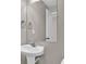 Clean powder room with a pedestal sink, mirror, and neutral wall color at 1280 Chandler Ridge Dr, Lawrenceville, GA 30045
