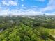Lush green canopy of trees surround neighborhood in aerial view under partly cloudy sky at 2510 Cumberland Se Ct, Smyrna, GA 30080