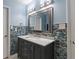 Bathroom vanity with gorgeous glass tiling and modern light fixtures at 2510 Cumberland Se Ct, Smyrna, GA 30080
