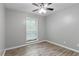 This cozy bedroom features hardwood floors, a ceiling fan, and a bright window at 2510 Cumberland Se Ct, Smyrna, GA 30080