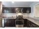 Modern kitchen featuring stainless steel appliances, granite countertops, and subway tile backsplash at 2510 Cumberland Se Ct, Smyrna, GA 30080
