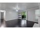 Bright living room with sliding glass doors, floating shelves and hardwood floors at 2510 Cumberland Se Ct, Smyrna, GA 30080