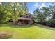 Expansive backyard features a screened porch, lush lawn, and inviting outdoor space perfect for entertaining at 4840 Spring Park Cir, Suwanee, GA 30024