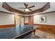 Basement with finished trim, and a black pool table under a ceiling fan at 4840 Spring Park Cir, Suwanee, GA 30024