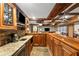 Close-up of basement bar with granite counters, cabinets, sink, and pendant lighting at 4840 Spring Park Cir, Suwanee, GA 30024