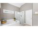 Well-lit bathroom with separate tub and shower at 4840 Spring Park Cir, Suwanee, GA 30024