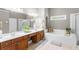 Bright bathroom with double vanity, soaking tub, separate shower, and natural light at 4840 Spring Park Cir, Suwanee, GA 30024