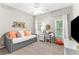 Cozy bedroom featuring a daybed with orange pillows and a dedicated workspace area at 4840 Spring Park Cir, Suwanee, GA 30024