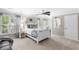 Bright bedroom with a cozy white bed, ceiling fan, and window at 4840 Spring Park Cir, Suwanee, GA 30024