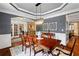 Elegant dining room features detailed trim work and a crystal chandelier, perfect for entertaining guests at 4840 Spring Park Cir, Suwanee, GA 30024