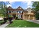 Beautiful brick home with a well-manicured lawn and attached two-car garage at 4840 Spring Park Cir, Suwanee, GA 30024