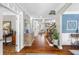 Elegant foyer with hardwood floors, decorative columns, and an open view of the living spaces and staircase at 4840 Spring Park Cir, Suwanee, GA 30024