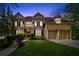 Stunning two-story brick home with a well-manicured lawn and a three-car garage, creating an inviting curb appeal at 4840 Spring Park Cir, Suwanee, GA 30024