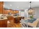 Eat-in kitchen with wood cabinets, stainless steel appliances, granite countertops, and a dining area at 4840 Spring Park Cir, Suwanee, GA 30024