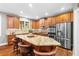 Gourmet kitchen featuring granite countertops, stainless steel appliances, and a large island with seating at 4840 Spring Park Cir, Suwanee, GA 30024