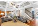 Open-concept living room with coffered ceilings, hardwood floors, and staircase to the upper level at 4840 Spring Park Cir, Suwanee, GA 30024