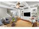 Bright living room boasts coffered ceilings, hardwood floors, built-in shelving, and staircase at 4840 Spring Park Cir, Suwanee, GA 30024