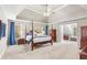 Spacious main bedroom with neutral carpet, ceiling fan, and sitting area with ample natural light at 4840 Spring Park Cir, Suwanee, GA 30024