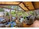 Cozy screened-in patio with wood ceiling, wicker furniture, ceiling fan, and views of the surrounding greenery at 4840 Spring Park Cir, Suwanee, GA 30024