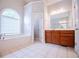 Bathroom with wooden cabinets, tub, shower, and white tile floor at 5995 Azalea Ridge Dr, Douglasville, GA 30135