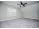 Bright bedroom with large window, plush carpeting, and a stylish ceiling fan at 5995 Azalea Ridge Dr, Douglasville, GA 30135