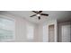 Bedroom with fan, carpet, two windows, and an open closet door at 5995 Azalea Ridge Dr, Douglasville, GA 30135