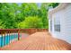 Wooden deck overlooking the backyard, with green trees and a refreshing pool, perfect for outdoor relaxation at 5995 Azalea Ridge Dr, Douglasville, GA 30135