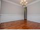 Dining area featuring hardwood floors, wainscoting, crown molding, and a chandelier at 5995 Azalea Ridge Dr, Douglasville, GA 30135