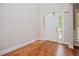 Bright foyer with hardwood flooring and a white front door featuring glass panes at 5995 Azalea Ridge Dr, Douglasville, GA 30135